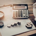 Calculator, coins, piggy bank, and financial report illustrating key personal finance and investment lessons.