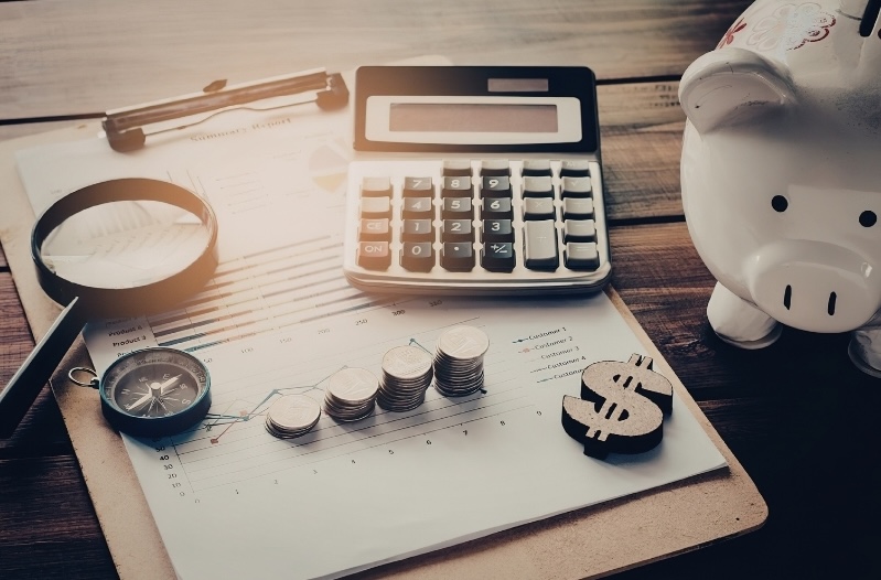 Calculator, coins, piggy bank, and financial report illustrating key personal finance and investment lessons.